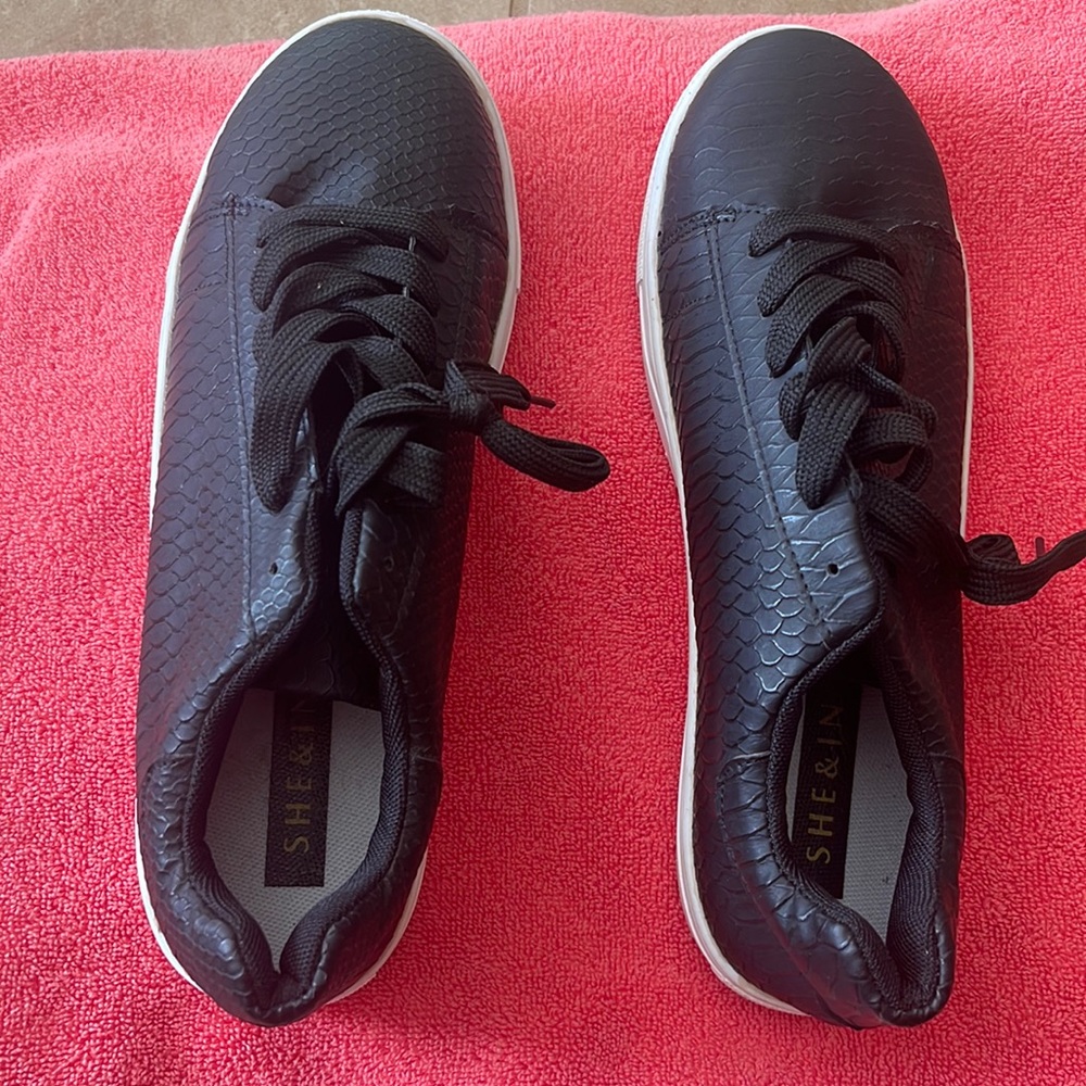 She&In black sneakers with a snakeprint design